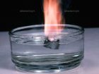Lithium reacting with water. Lithium (Li) is a highly reactive metallic element. It is light enough to float on water, with which it reacts violently to produce hydrogen (H2) gas and lithium hydroxide (LiOH).